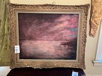 Front view of framed oil seascape in ornate antique frame