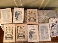 Eight Harper’s magazines on tabletop, showing covers and open pages