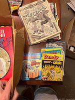 Stack on table showing The Confusing Spider-Dude, Beano and Dandy digests, assorted comics