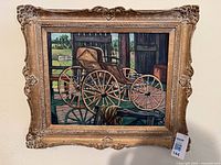 Front view of framed oil painting showing carriage scene and ornate gilt frame