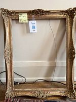 Full view of first ornate gold frame showing wired back and post-it with dimensions