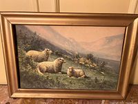 Full view of framed watercolour depicting three sheep in a mountain landscape
