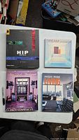 Four hardcover architecture and interior design books on table