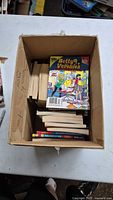 Box with assorted Archie comic digests, top view shows Betty & Veronica issue and other spines