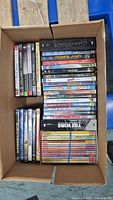Top view of box showing vertical row of standard cases and horizontal row of assorted DVDs