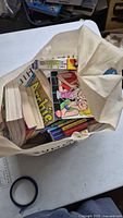 Bag containing stack of Archie digest and trade paperback comics