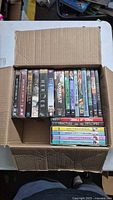 Overall view of DVD lot in cardboard box
