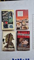 Front covers of all four Sherlock Holmes related books