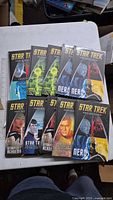 Front covers of 10 Star Trek Graphic Novel Collection hardcovers spread out