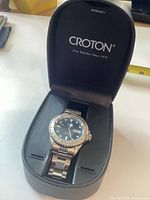 Watch in open Croton box showing dial and bracelet