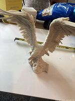 Front view of white resin eagle figurine with wings spread