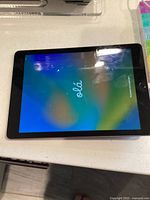 Front view of Apple iPad powered on showing setup screen