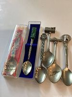 Group of five souvenir spoons showing overall condition and variety
