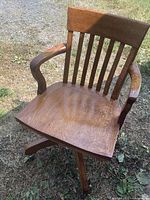 Full view of oak swivel office chair showing seat, backrest and arms