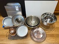 Group shot of all bakeware items including bowls, pans, molds, sheets, stand and rack