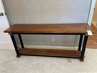 Front view showing entire console table with rattan shelf and legs