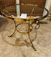 Full view of round brass table with glass top