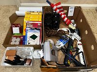 Overview of entire box with felt pads, moth traps, shelf liners, electrical items, Thermapen box