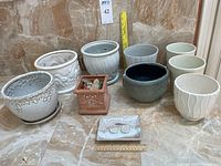 Group shot of all eight planters and soap dish with ruler for scale