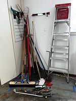 Corner view showing ladder and most long-handle tools