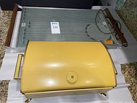 Yellow buffet server and Salton Hotray tray side by side
