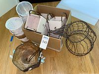 Group shot showing wood planter boxes in carton, woven holders, stacked wicker baskets