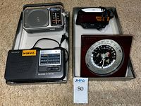 Panasonic RF-2400 radio, Sony ICF-36 radio, Seiko GMT clock displayed together