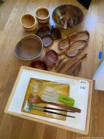 Group shot of all wooden bowls, divided dishes, utensils in tray