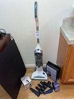 Full view of Shark Navigator Freestyle vacuum with attachments, filter box and vacuum bag box