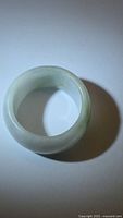 Top view of pale green jade band ring showing smooth exterior