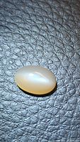 Front view of peach moonstone showing cat’s eye line