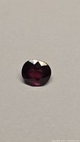 Front view of faceted ruby on neutral background