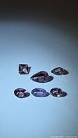 Six faceted stones on blue background