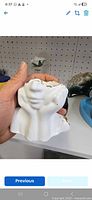 Front view of white sculpted gypsum concrete jewellery box held in hand