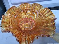 Interior view showing iridescent colour, pattern detail, scalloped rim