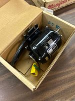 Motor in box showing housing, wiring and connector