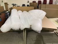 Bubble wrap rolls lying on stacked corrugated sheets