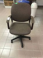 Front view of brown fabric office chair with arms and five-star base