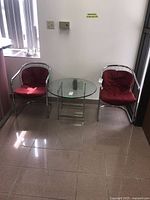 Both cantilever chairs with glass table in foreground