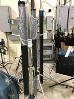 All three wrapped screen frames on tripod bases in storage area