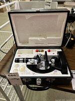 Microscope in open case with vials visible