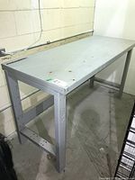 Full view of gray steel workbench in corner