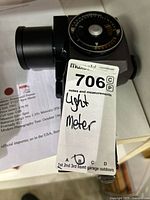 Side view of Honeywell Pentax spot meter with MaxSold lot tag