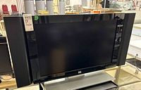 Front view of HP LCD HDTV with side speakers and stand