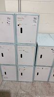Front view showing two locker columns; right column of three white-door lockers with light blue frame is the lot