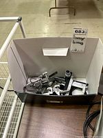 Box containing assorted microscope and optical lab parts