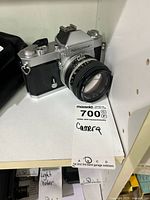 Front left view of Nikkormat body with attached Nikkor 50mm lens