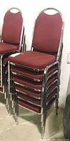 Full stack of six burgundy fabric banquet chairs with chrome frames