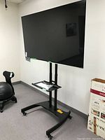Front view of LG TV mounted on rolling stand