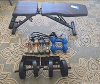 Overview of bench, dumbbells, plates, bands, ankle weights